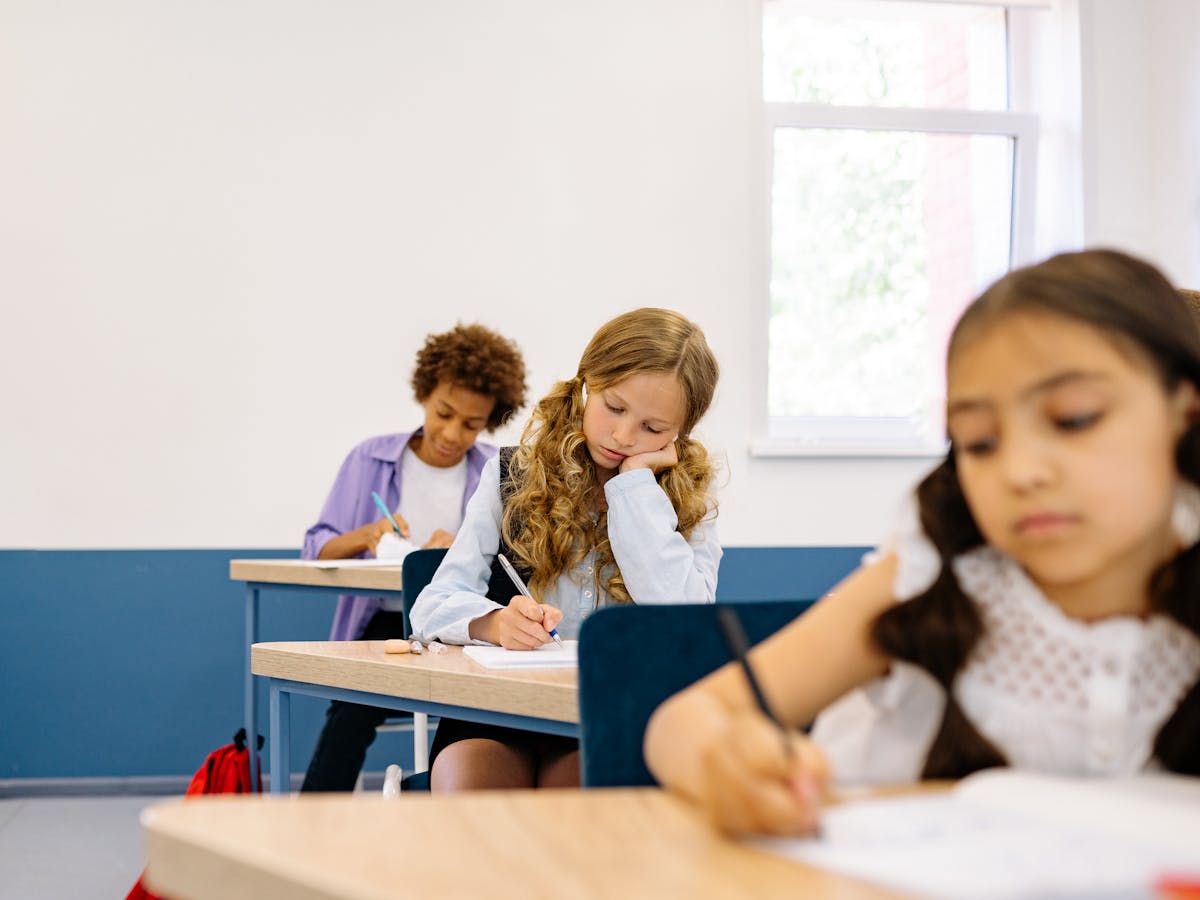 Children writing assignments in a classroom
