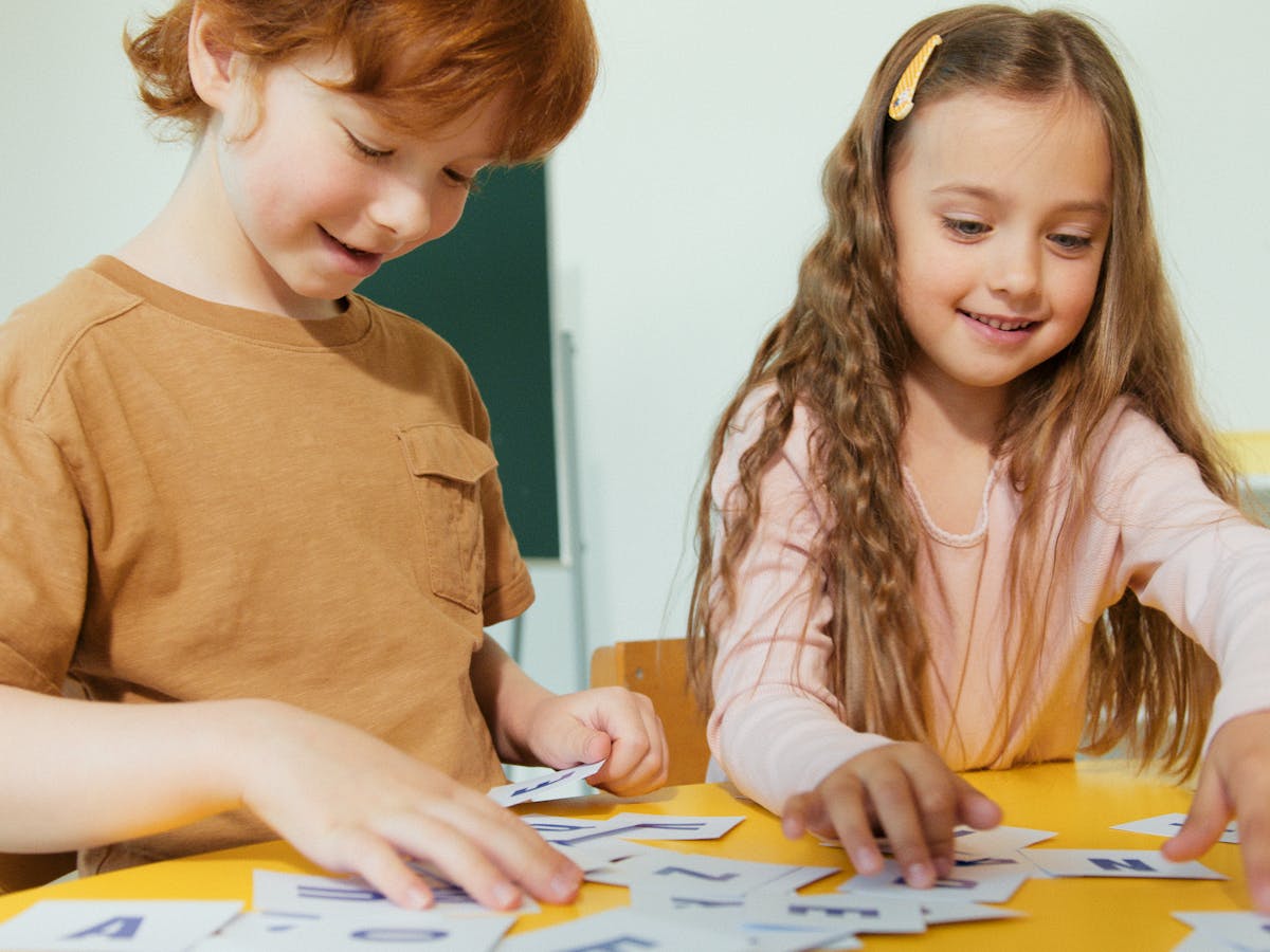 Children practicing letters with flashcards