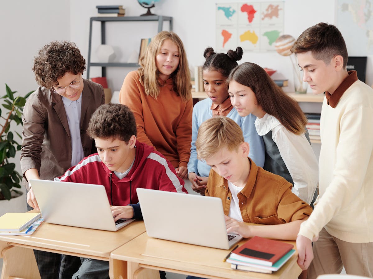Students learning with laptops in a tutoring classroom